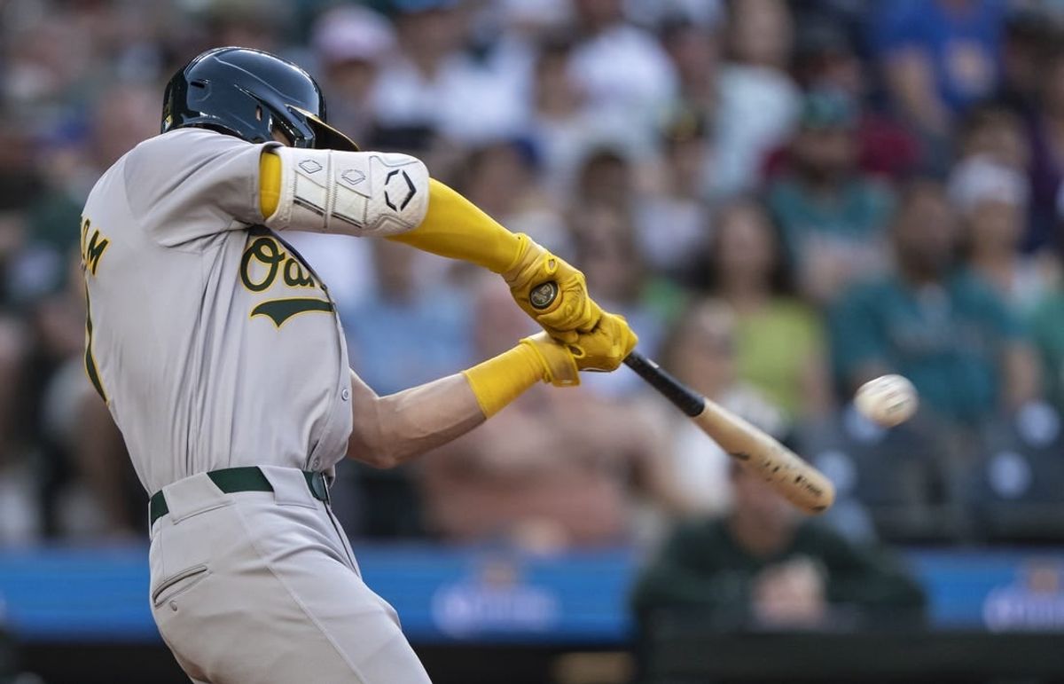 A's pull away late to pound Mariners